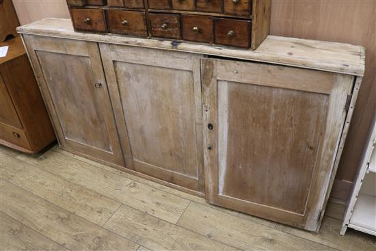 A stripped pine panelled cupboard, W.186cm